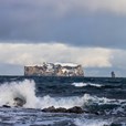 Rock in the foamy Icelandic ocean